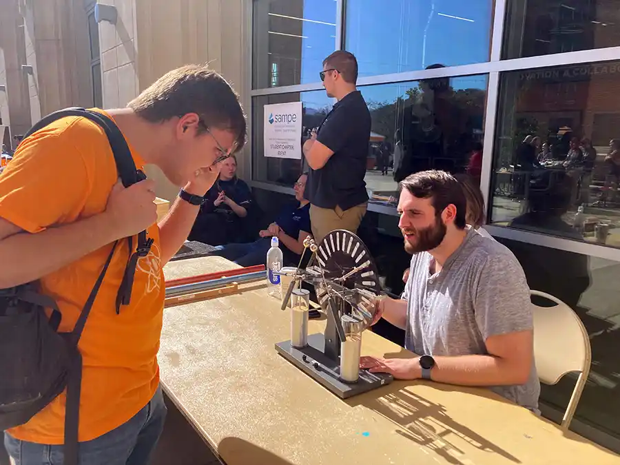 A photo of two students in the Society of Physics students club, at an Engineers Day event.