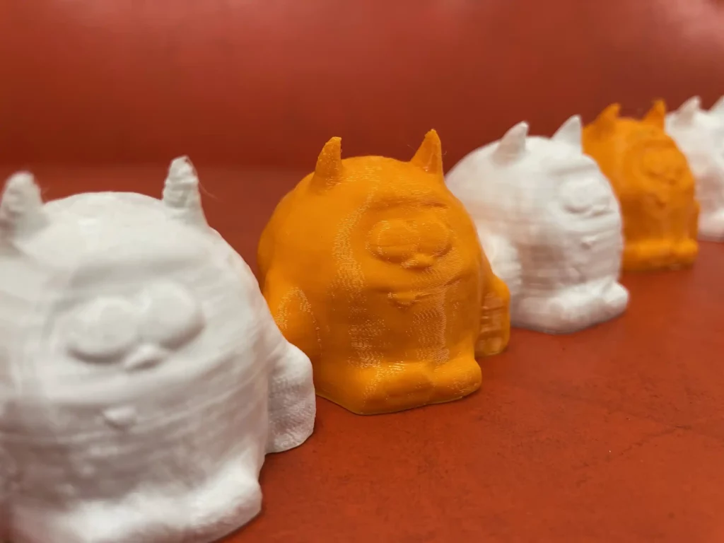 White and Orange printed YETI figurines