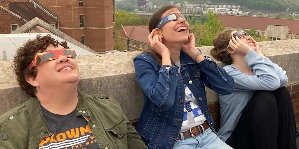 Photo of eclipse watchers on the roof of the Nielsen Physics Building