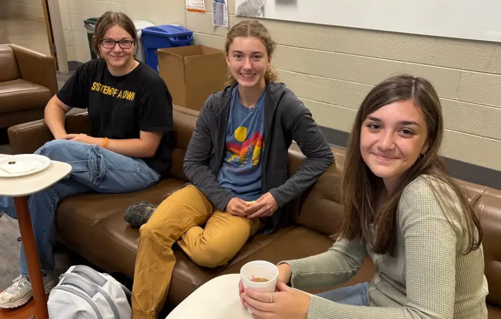 Three people sitting on a sofa