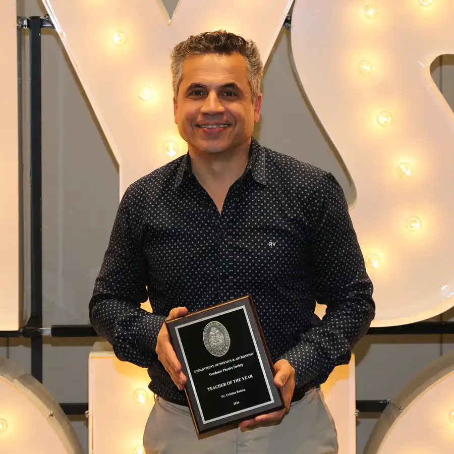 A photo of Cristian Batista with his 2026 GPS Teacher of the Year plaque