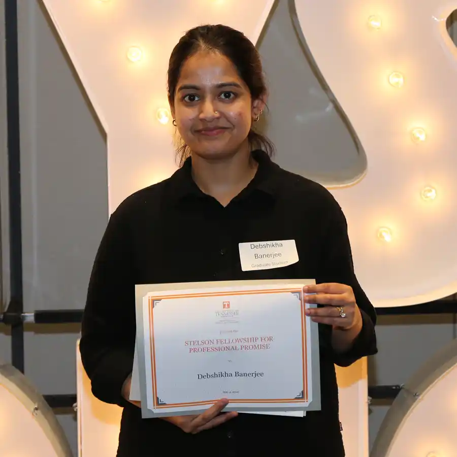 A photo of Debshikha Banerjee with her 2026 UT Physics Honors Day certificate