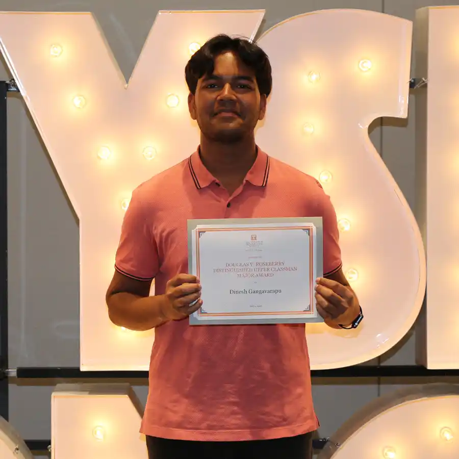 A photo of Dinesh Gangavarapu with his 2026 UT Physics Honors Day certificate